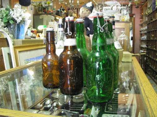 6 EMPTY GROLSCH BOTTLES WITH STOPPERS..... many people use these for sauces or salad dressings!!!