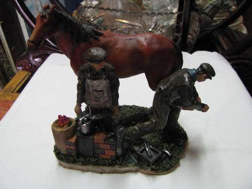 A REALLY LOVELY FARRIER STATUE WITH HORSE BEING SHOED