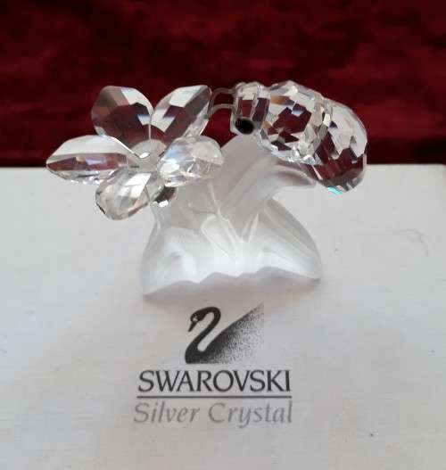 A SWAROVSKI SILVER CRYSTAL BEE WITH FLOWER