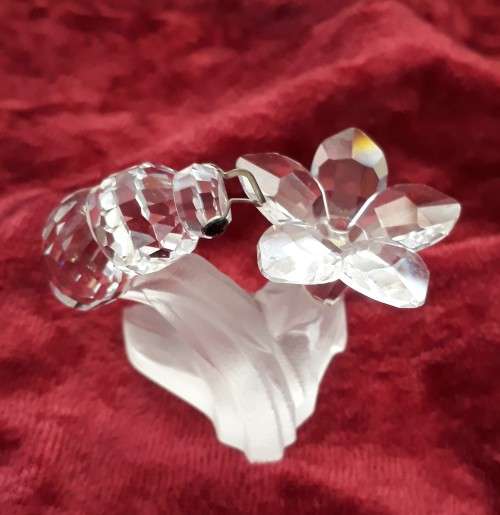 A SWAROVSKI SILVER CRYSTAL BEE WITH FLOWER