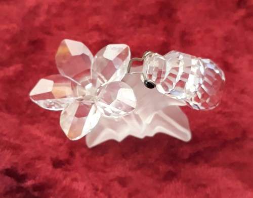 A SWAROVSKI SILVER CRYSTAL BEE WITH FLOWER