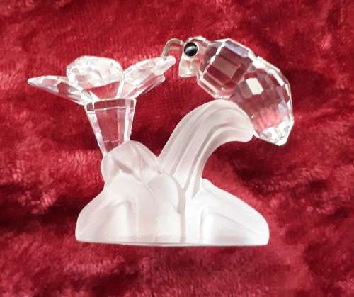 A SWAROVSKI SILVER CRYSTAL BEE WITH FLOWER