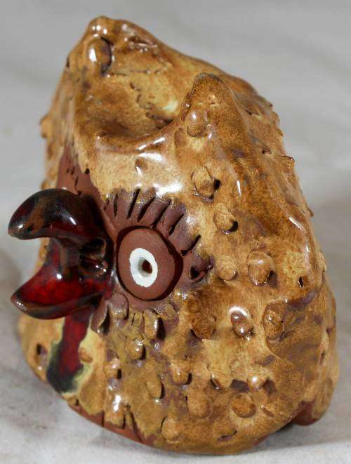 Brown owl with a red beak