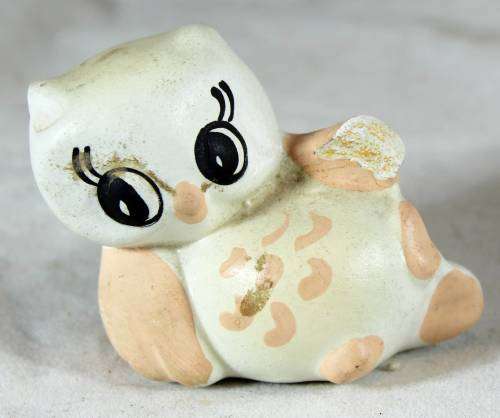 Owl chick lying down
