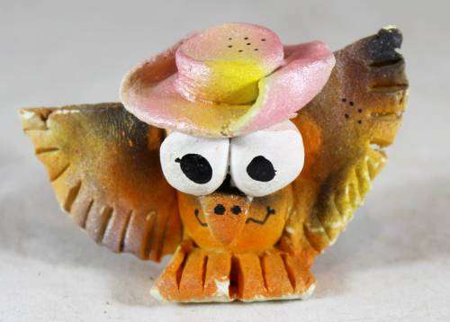Miniature owl with a hat