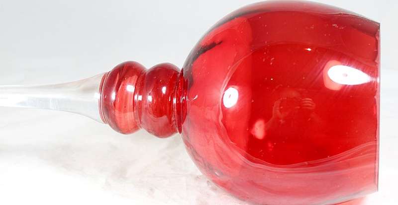 Red glass - stemmed bulbous candle holder