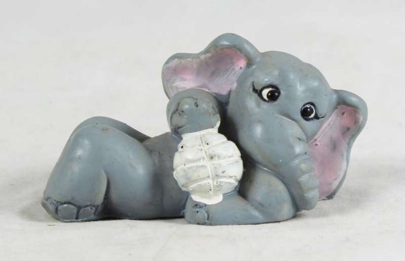 Elephant laying down with a ball