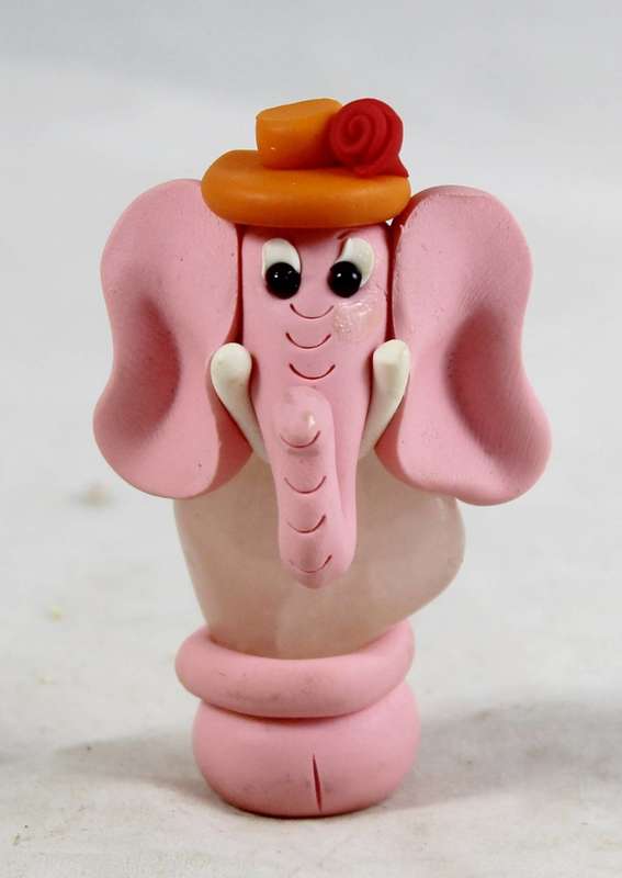 Top hat elephant mounted on a stone