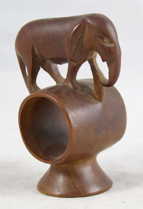 Carved wooden elephant on a barrel