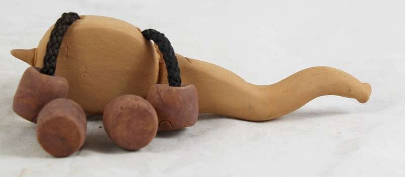 Clay elephant with rope legs