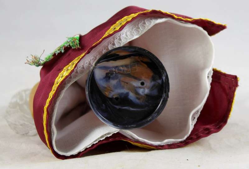 Girl doll carrying an urn in traditional clothes