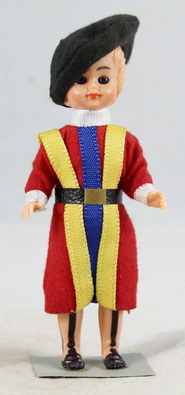 Small boy with traditional clothes doll