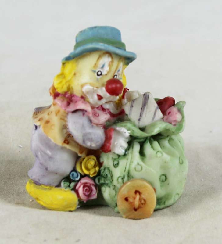 Miniature clown carrying bag of presents