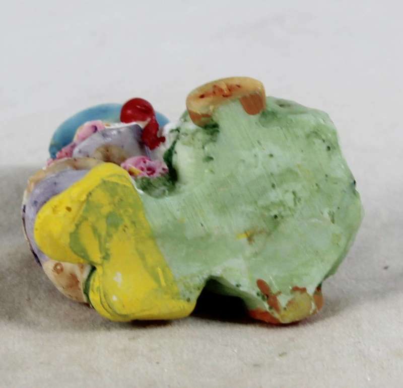 Miniature clown carrying bag of presents