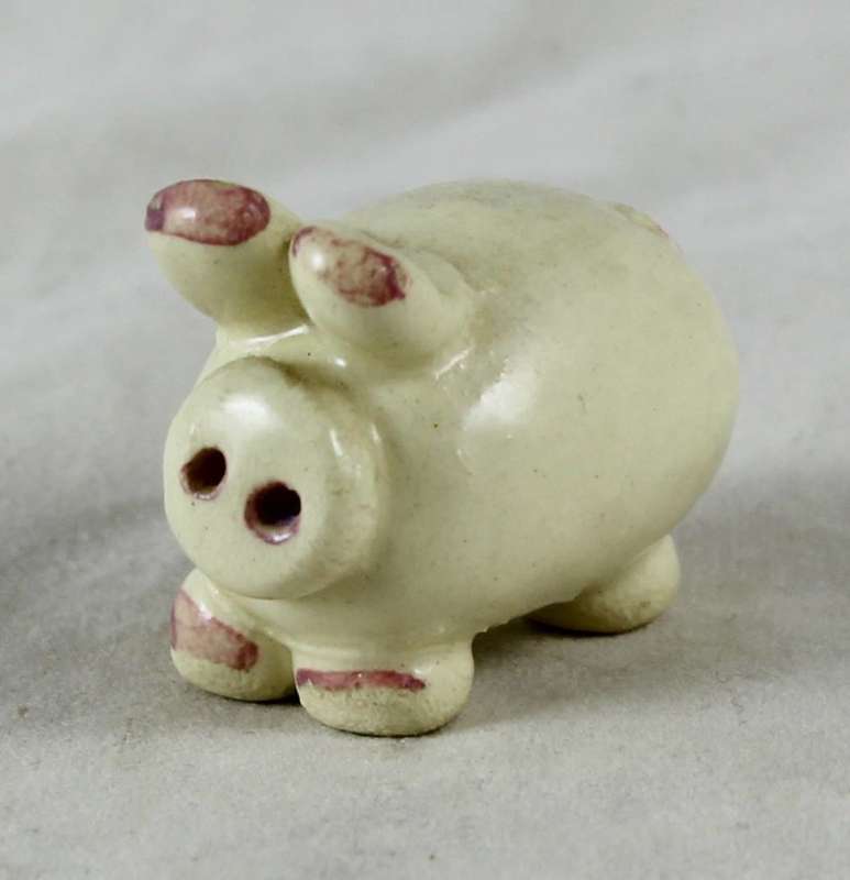 Small beige pig with pink ears