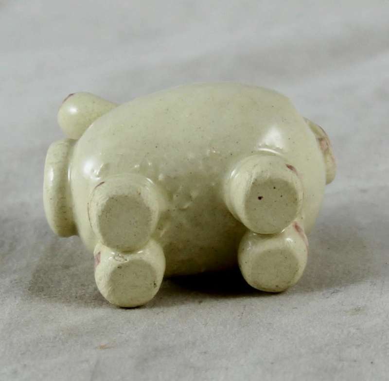 Small beige pig with pink ears