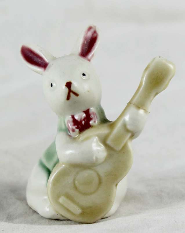 Little white rabbit playing guitar