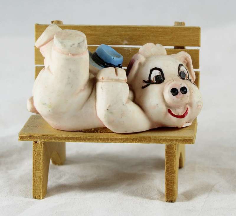 Quirky pig laying on bench