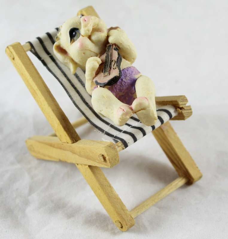 Pig playing guitar - relaxing on beach chair