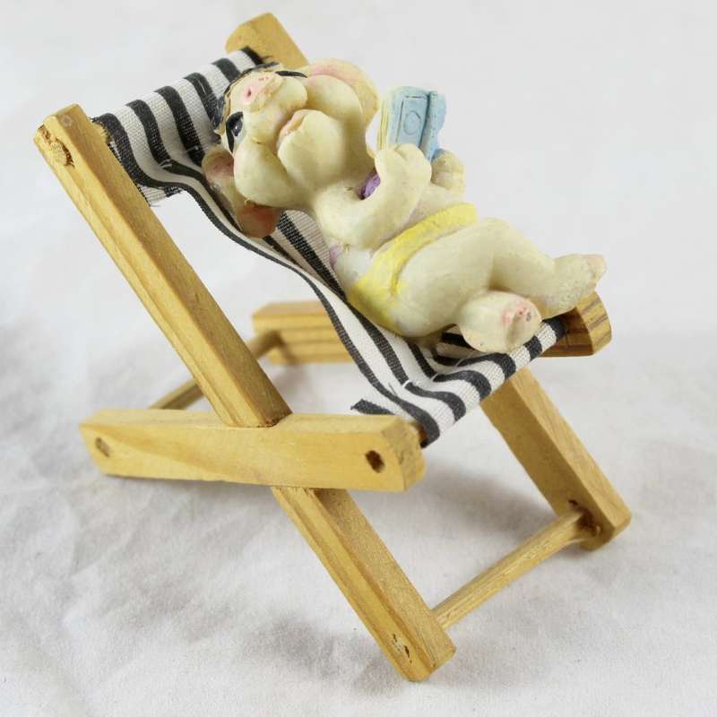 Pig with a book - relaxing on beach chair