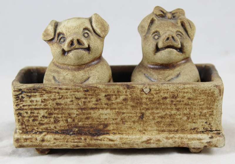Pig couple sitting in trough