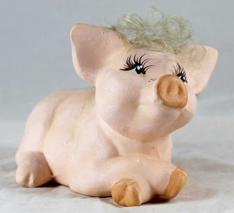 Pink pig with crossed legs