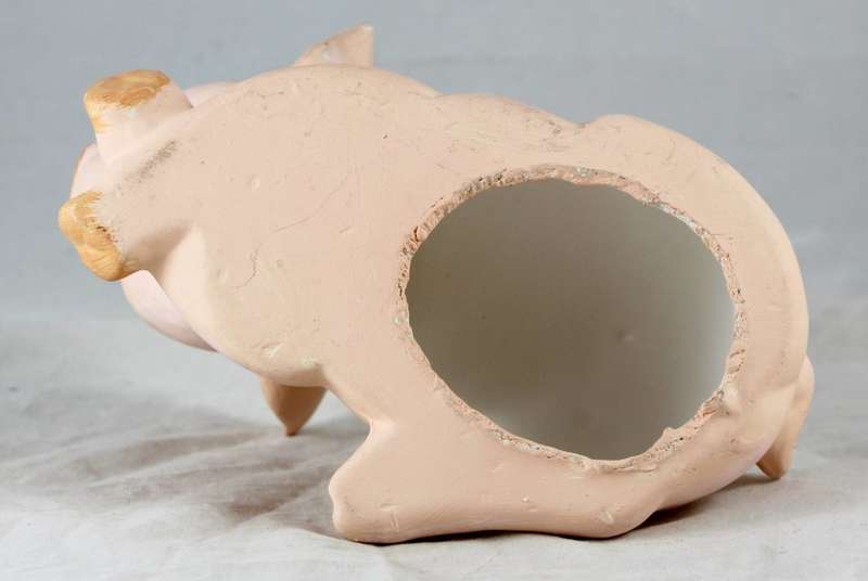 Pink pig with crossed legs