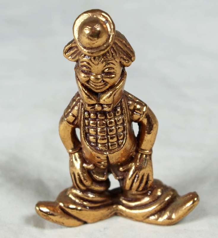 Golden lead figurine - clown with neck brace