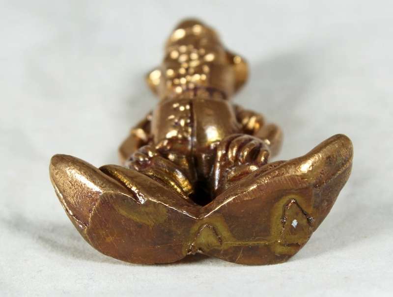 Golden lead figurine - clown with neck brace