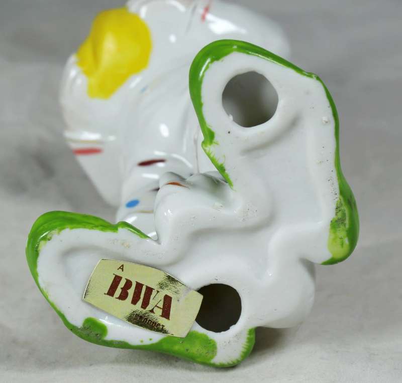Clown with a head between feet