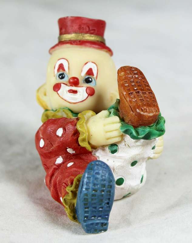 Baby clown holding its leg