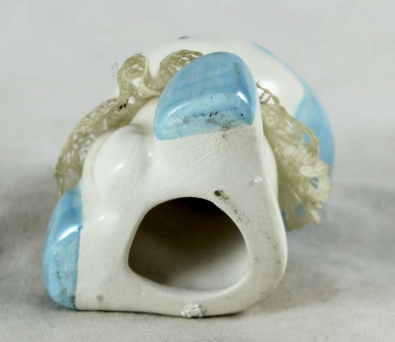 Small porcelain baby with lace collar - light blue head