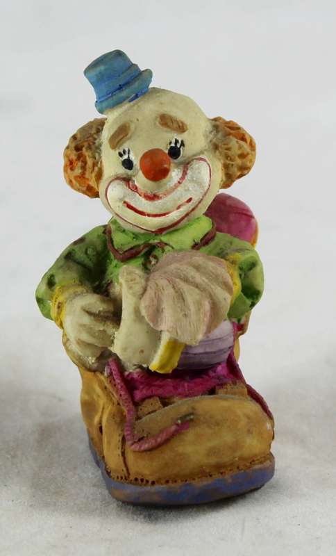 Small clown sitting in shoe