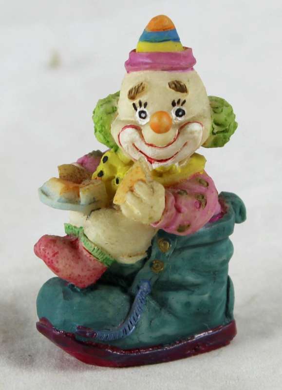 Small clown sitting & eating in shoe