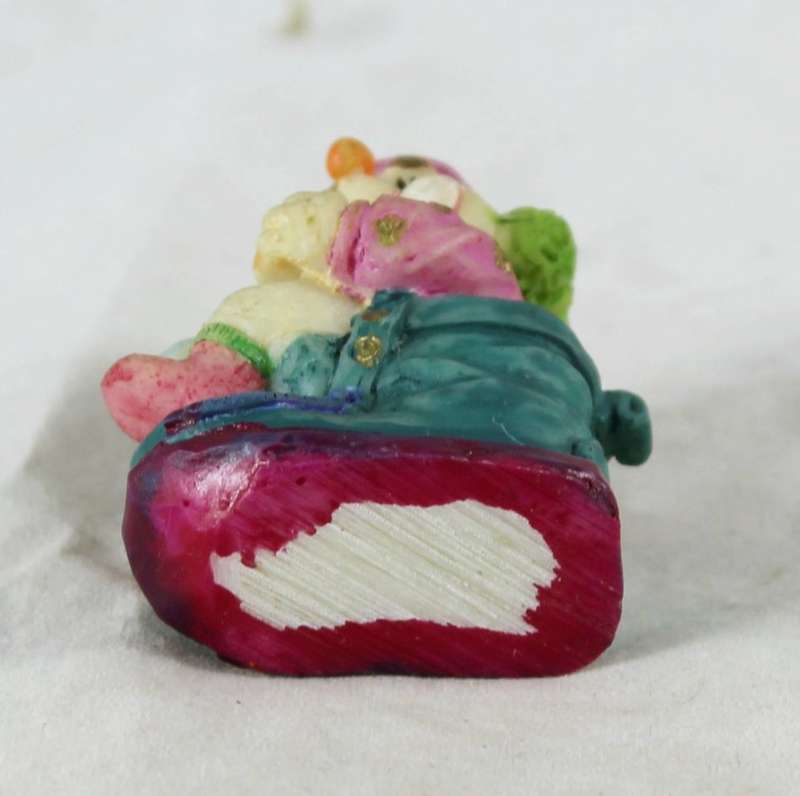 Small clown sitting & eating in shoe