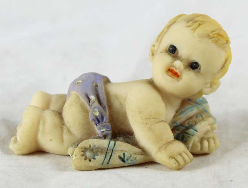 Miniature baby with blanket