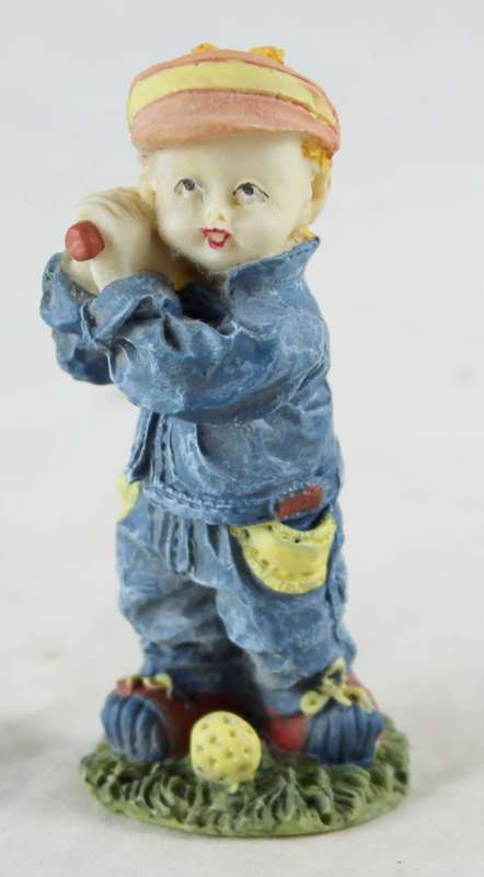 Miniature little boy playing golf
