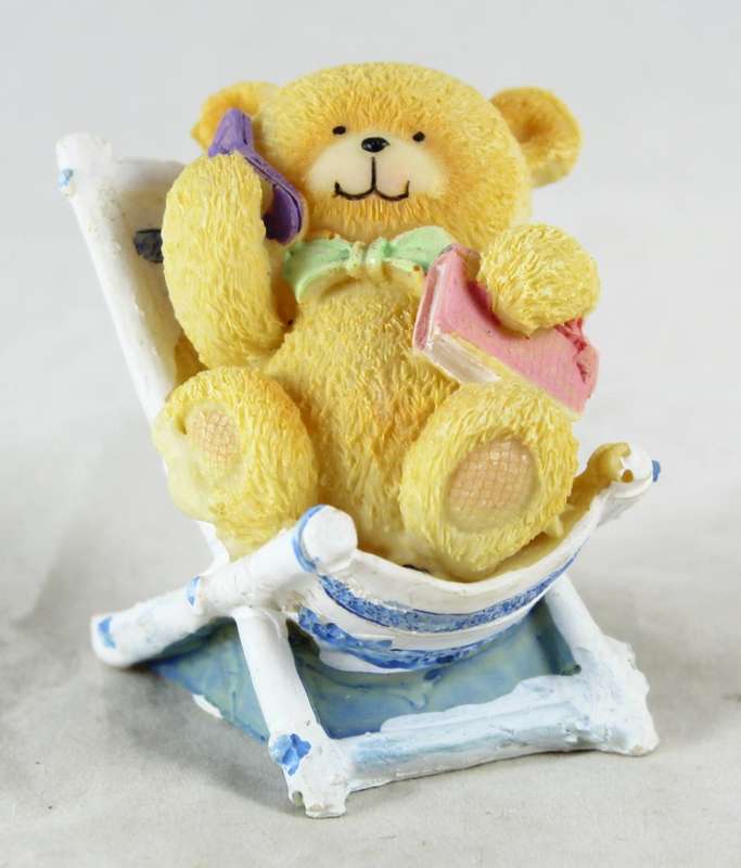 Bear on beach chair - talking on cellphone