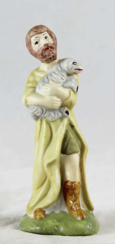 Small ceramic man holding lamb