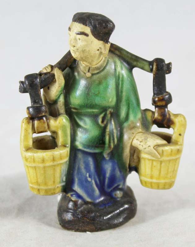 Mud woman carrying buckets