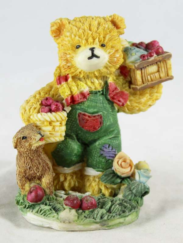 Bear carrying apples with dog