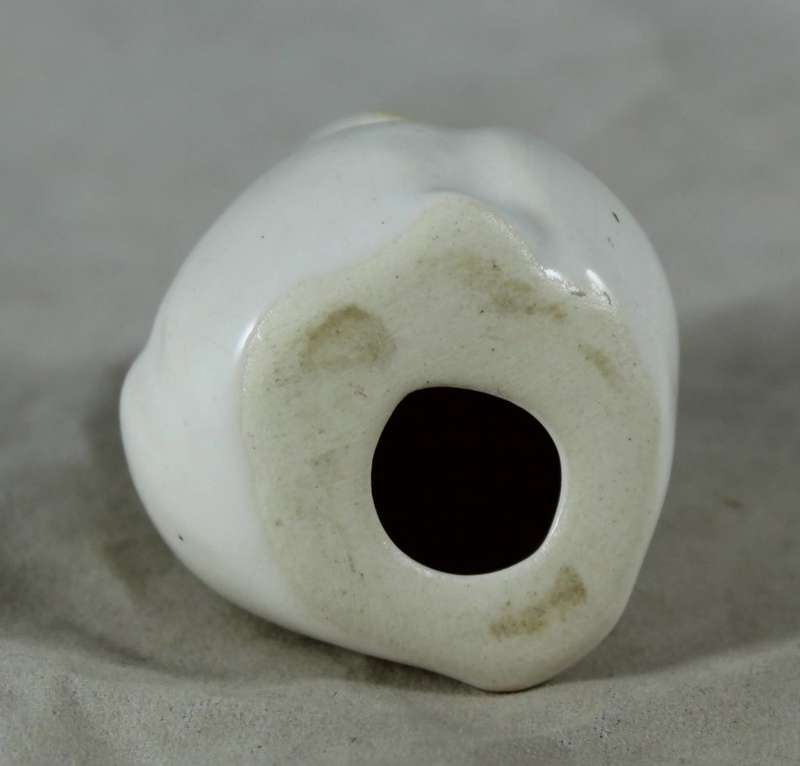 Miniature porcelain owl with large yellow eyes