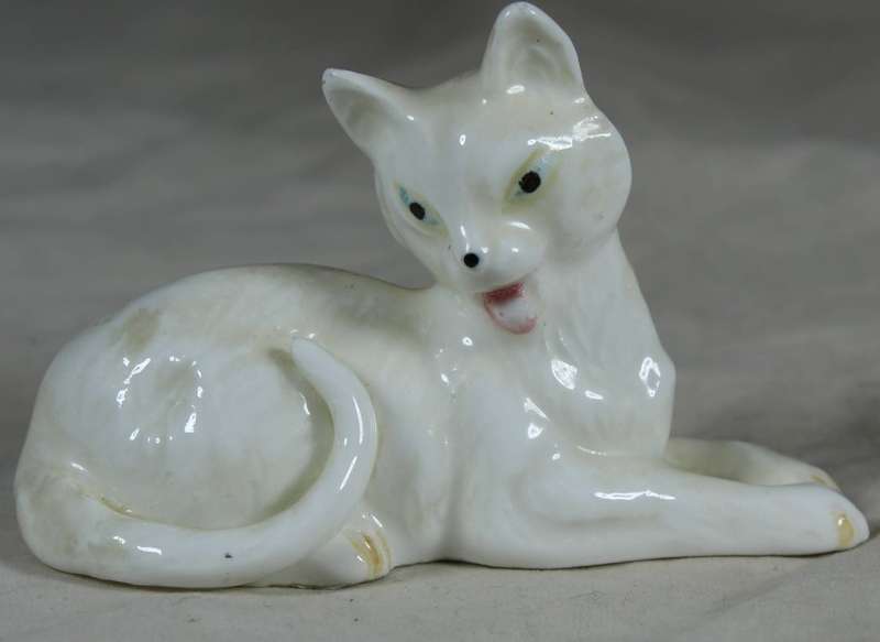 Porcelain small dog lying down