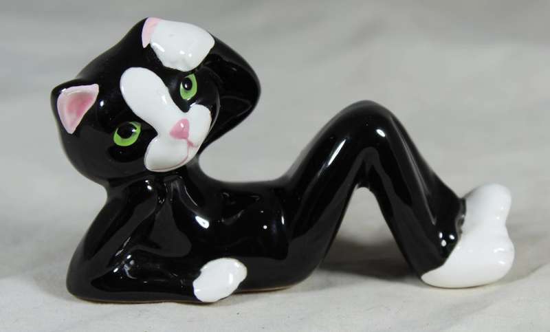 Funky porcelain cat reclining