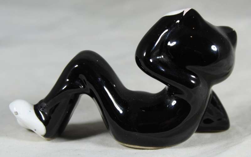 Funky porcelain cat reclining