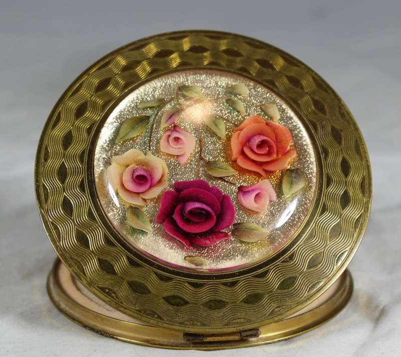 Domed rose embossed powder compact