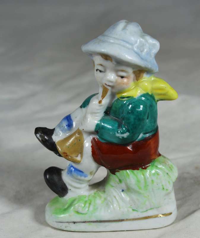 Ceramic boy playing his horn