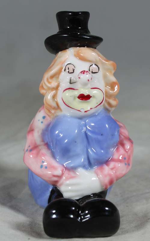 Seated clown with pulled up legs