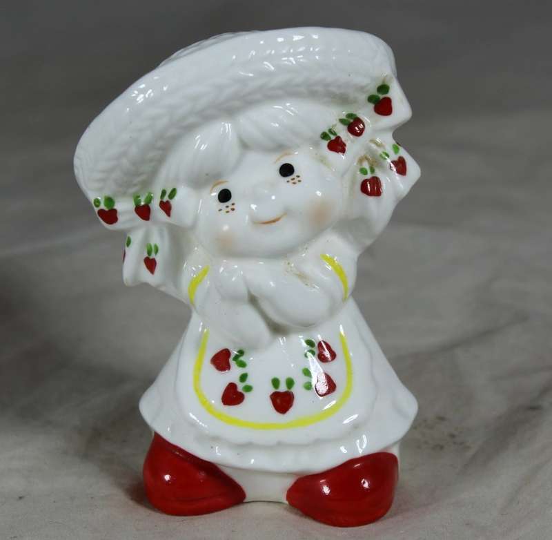 Porcelain happy girl with strawberry dress