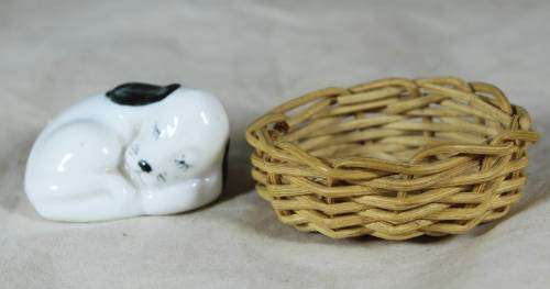 Porcelain puppy sleeping in a basket